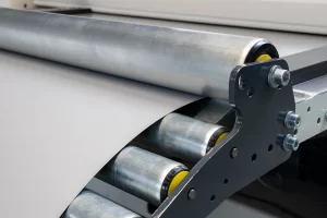 infeed of sheet metal to cut to length machine on the infeed table with rollers